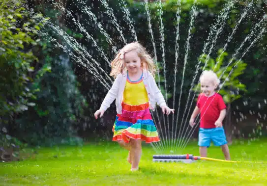 kids playing in sprinkler