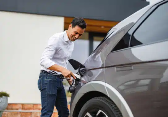 jolly man charging an EV